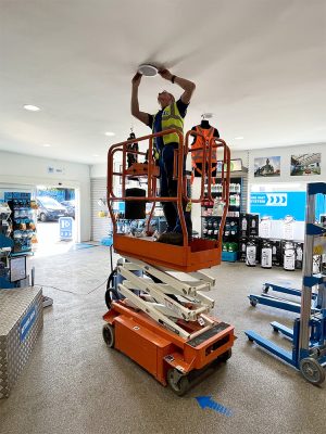 10ft scissor lift being operated for lighting installations.
